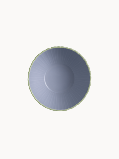 A top-down view on a two-toned ceramic bowl with a finely ribbed, mint  exterior and a smooth lavender interior, on a plain background.