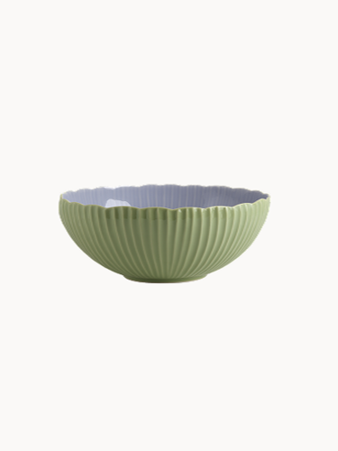 A two-toned ceramic bowl with a finely ribbed, mint  exterior and a smooth lavender interior, on a plain background.