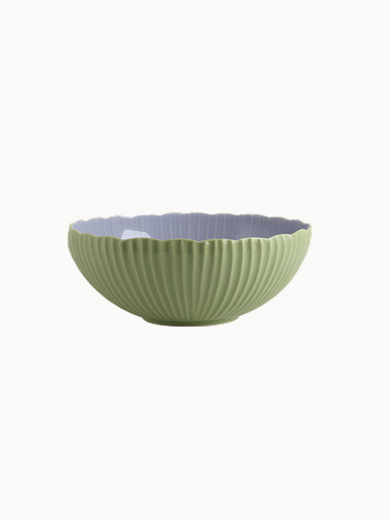 A two-toned ceramic bowl with a finely ribbed, mint  exterior and a smooth lavender interior, on a plain background.