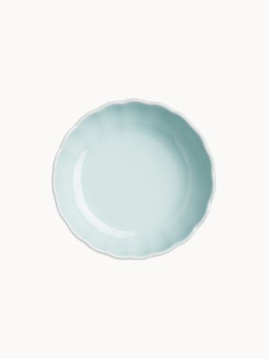 A top-down view on a pastel blue ceramic cake stand, on a light background.