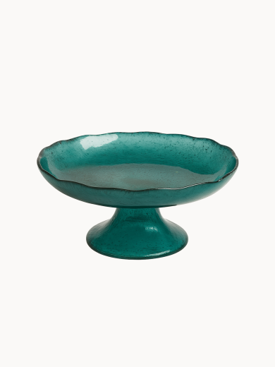 A vibrant teal cake stand with a distinct ruffled edge and a short, conical teal base. ona light cream white background.
